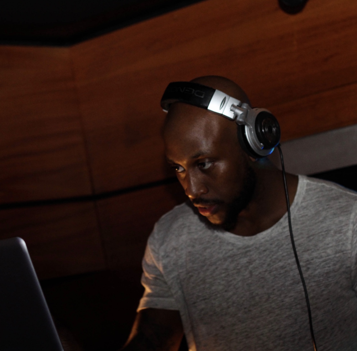 DJ DC wearing headphones at the booth